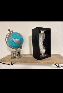 a wooden shelf with a clock and a globe on it at PDX Studios in Portland