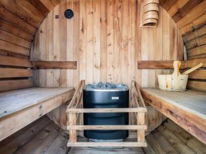 a sauna with two benches and a trash can at Cabin W Hot Tub, Sauna, King Beds, National Park in Otterburn +80 photos
