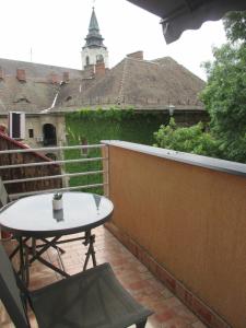 une table et une chaise sur un balcon dans l'établissement Elizabet Apartman, à Szarvas