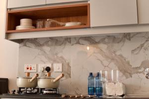 a kitchen counter with two pots on a stove at Eloura Homes Stanley Studio in Kiambu