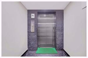 an elevator with a green floor in a corridor at Hotel Mahabodhi Residency Near Railway Station-Fully Air Conditioning Hotel - Luxury & Spacious Room- A Top Rated Hotel in Cuttack