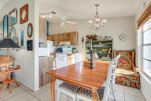 a kitchen and dining room with a wooden table at Pool Access Condo 4 Mi to Bradenton Riverwalk! in Cedar Hammock