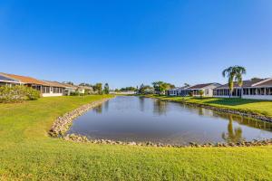 a river in the middle of a yard with houses at Pool Access Condo 4 Mi to Bradenton Riverwalk! in Cedar Hammock