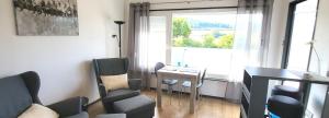 a living room with a table and chairs and a window at Huus-Weitblick an der Weser in Polle +12 photos