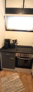 a kitchen with a black stove and a window at Huus-Weitblick in Polle +1 photo