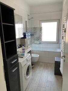a small bathroom with a washing machine in it at Sweet Home Appartements 2 in Bottrop +25 photos