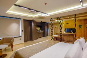 a hotel room with a large bed and a kitchen at Del Mar City View in Cartagena de Indias