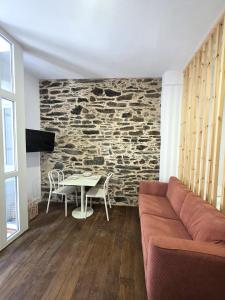 a living room with a couch and a table at Estudio Casco Histórico Betanzos in Betanzos