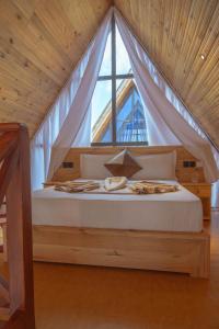 a bedroom with a bed with a large window at Nakupenda Boutique in Mwombali +23 photos