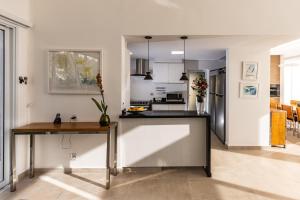 Una cocina y una sala de estar con encimera. en Paraíso em Boituva - chácara nova, moderna, 2100 m, em condomínio -10 PESSOAS, en Boituva