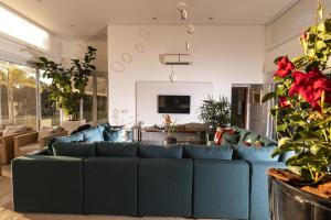 sala de estar con sofá azul en Paraíso em Boituva - chácara nova, moderna, 2100 m, em condomínio -10 PESSOAS, en Boituva