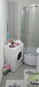 a bathroom with a washing machine and a shower at Sarajevo Alifakovac in Sarajevo