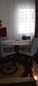 a table and two chairs in a room with a window at Sarajevo Alifakovac in Sarajevo