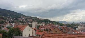 a view of a city with buildings and mountains at Sarajevo Alifakovac in Sarajevo