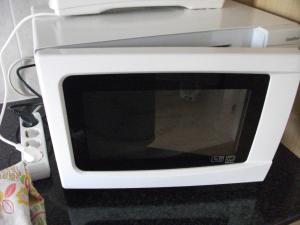 a white microwave oven sitting on top of a counter at VISIt CASTELO BRANCO in Castelo Branco +45 photos