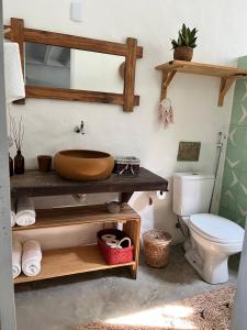 a bathroom with a sink and a toilet at KOA Loft - Praia de Moitas in Amontada