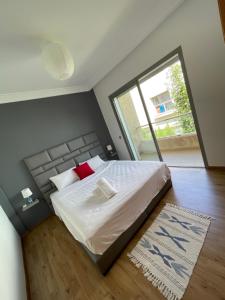 a bedroom with a large bed with a large window at Villa a darbouaza in Casablanca +22 photos