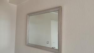 a mirror hanging on a wall in a room at Departamento 610 in Temuco