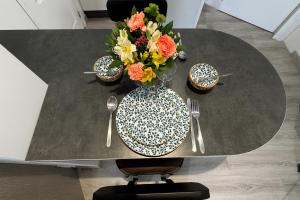 a table with a vase of flowers on top of it at Beau Studio Neuf proche du centre et de Nausicaa in Boulogne-sur-Mer