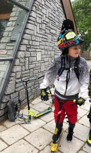 a young child standing on skis next to a building at Ferienhaus Valsora in Sölden