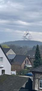 a view of a town with houses and a large antenna at Sweet Home Appartements 2 in Bottrop