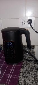 a black appliance plugged into a wall in a kitchen at Lam DEPARTAMENTO TEMPORARIO in Resistencia