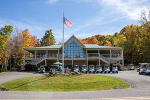 a large house with an american flag in front of it at ML246 Spacious Condo Mtn & Lake views fireplace in Snowshoe