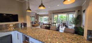 a kitchen with a counter top and a living room at Jasmine Villas #7 in Castries