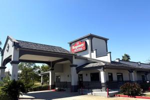 a gas station with a sign on it at Hotel O Regency Suites Houston - IAH Beltway 8 in Houston