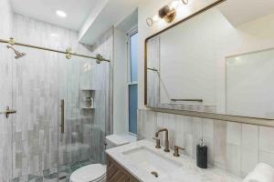 a bathroom with a sink and a toilet and a mirror at Stylish Studio Sleeps Four - 10 mins to DT (B) in Philadelphia