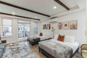 a bedroom with two beds and a living room at Large Studio w 2 Beds and Balcony (C) in Philadelphia