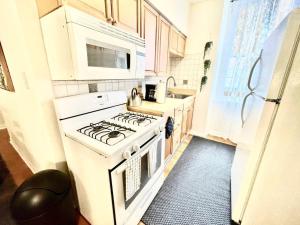 a kitchen with a white stove and a microwave at Incredible Location - Large Center City 2 BR in Philadelphia +11 photos