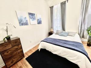 a bedroom with a large bed and a dresser at Incredible Location - Large Center City 2 BR in Philadelphia