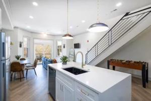 a kitchen and living room with a staircase at 2BR - Across from Fairmount Park -10 mins to DT in Philadelphia