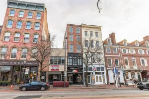 a city street with buildings and a car parked on the street at Bi-Level 2BR Loft in Old City in Philadelphia