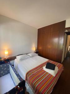 a bedroom with a bed with a laptop on it at Tróia Resort - Paradise in Troia +17 photos