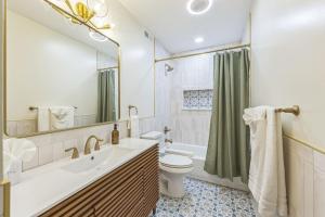 a bathroom with a sink and a toilet and a mirror at New 2BR Across from Fairmount Park - 10 Mins to DT in Philadelphia +11 photos