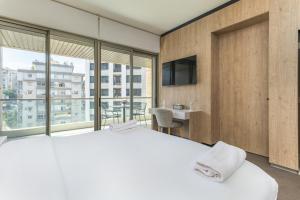 a bedroom with a large bed and a large window at Apex Studio & Balcony in Jounieh in Al Bāţiyah