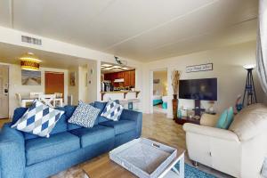a living room with a blue couch and two chairs at Marlin Arms Condominiums #10 in South Padre Island