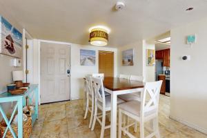 a kitchen and dining room with a table and chairs at Marlin Arms Condominiums #10 in South Padre Island +24 photos