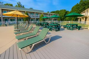 a group of lounge chairs and umbrellas on a deck at Players Club Resort in Hilton Head Island