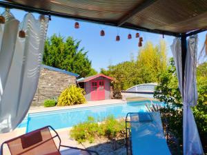 a view of a swimming pool from the patio of a house at La maisonnette de Joséphine in Saint-Jean-des-Mauvrets