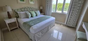 a bedroom with a large bed and a window at Jasmine Villas #7 in Castries +20 photos