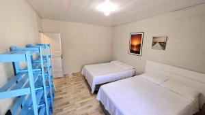 Postel nebo postele na pokoji v ubytování Residencial Praia da Daniela