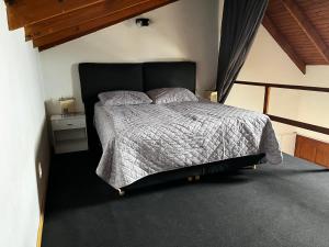 a bedroom with a large bed with a black headboard at Genoveva, descanso y calma in Neuquén