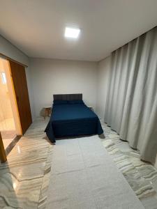 a bedroom with a blue bed in a room at Vieiras in Embu +3 photos