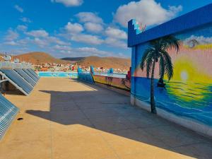 a mural of a palm tree next to a pool at Mirleft Beach in Mirleft