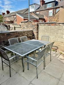 a table and chairs sitting on a patio at 5 Bed 2 Shower Home in Stoke on Trent
