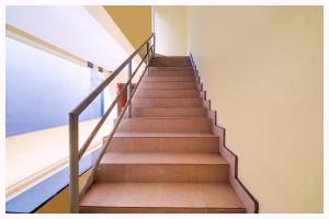 a staircase in an office building with a stair railing at Hotel Kanika Palace Near Railway Station in Cuttack