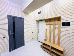 a garage with a door and a bench next to it at Action in Bishkek